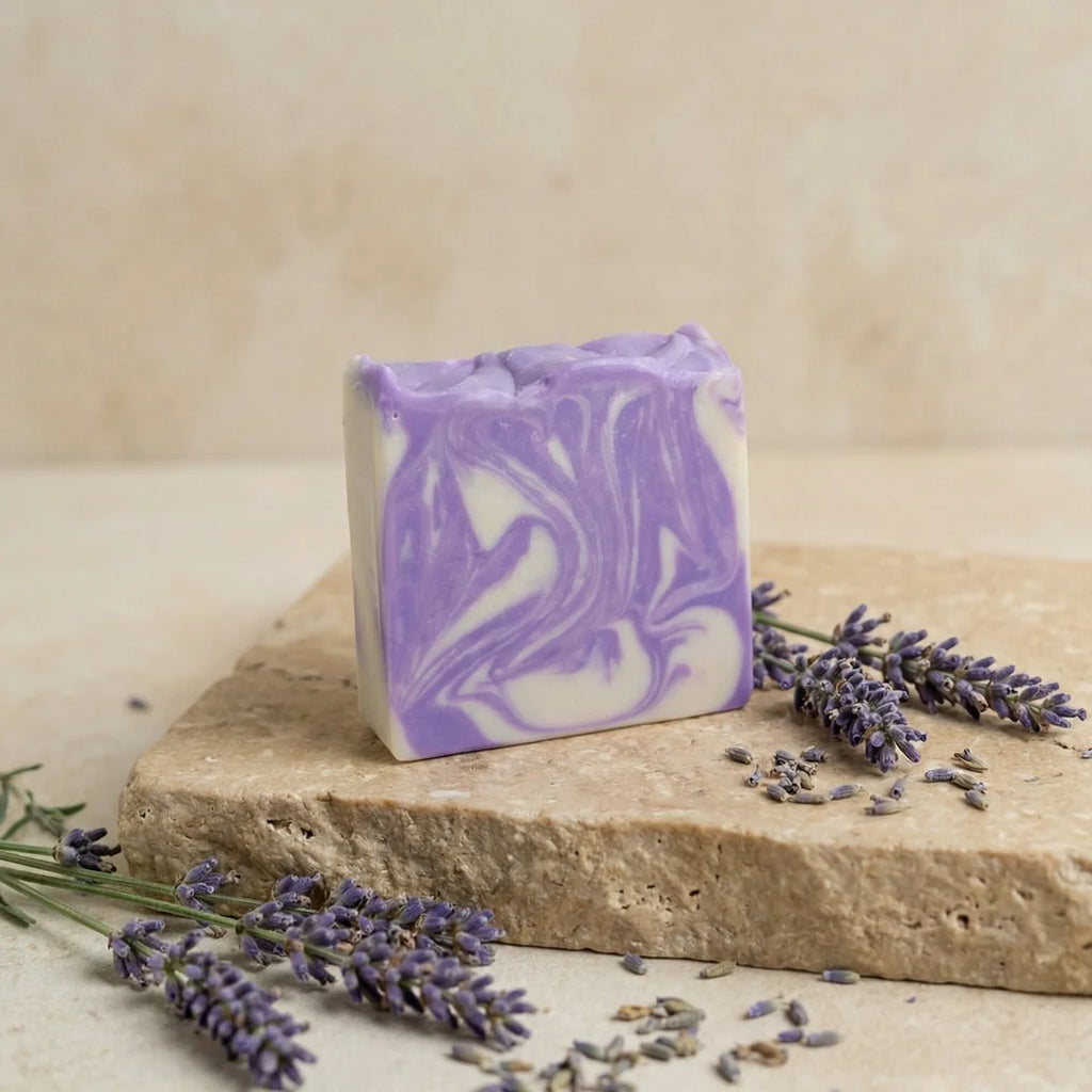 Degleri lavender chamomile olive oil soap bar with purple and white swirl design, resting on a stone slab with fresh lavender sprigs