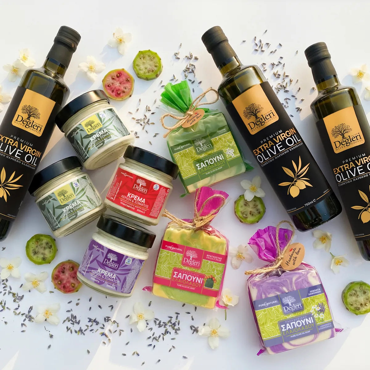 Degleri full Greek product collection flat lay — premium extra virgin olive oil bottles, hand and body cream jars, and gift-wrapped pure olive oil soaps