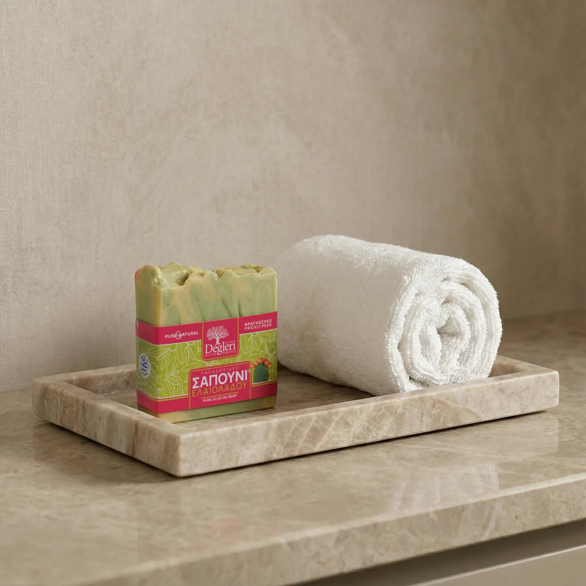 Degleri prickly pear olive oil soap bar on a marble tray with a rolled white towel — natural Greek skincare