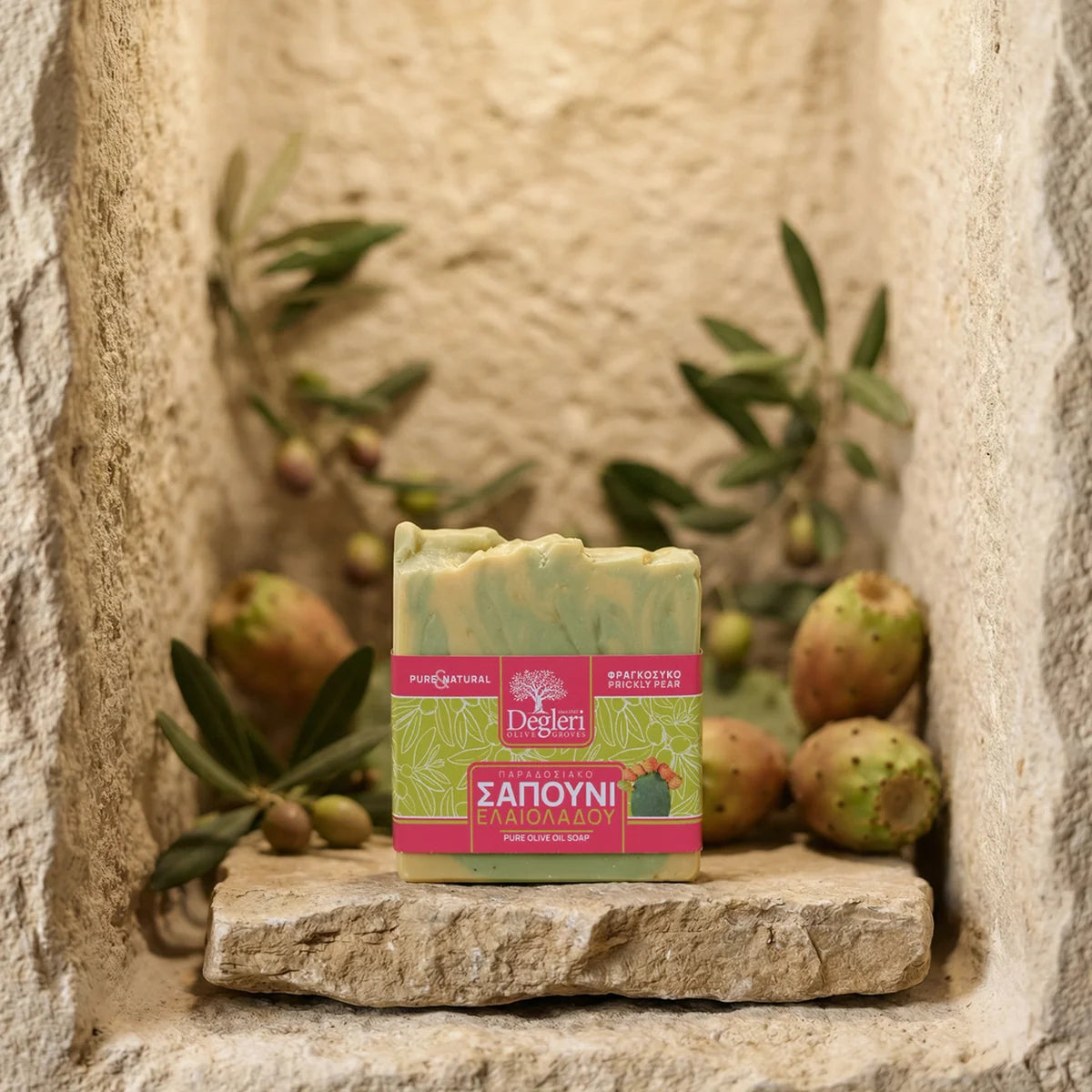 Degleri prickly pear pure olive oil soap bar in a traditional Greek stone wall niche, surrounded by olive branches and green olives