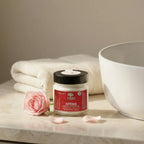 Degleri rose hand and body cream jar with natural ingredients, photographed with a fresh pink rose — Greek olive oil skincare